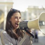 Content Marketing Ecommerce - Cheerful young woman screaming into megaphone