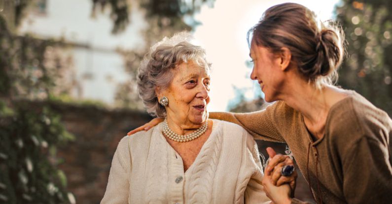 Relationship Influencer - Joyful adult daughter greeting happy surprised senior mother in garden