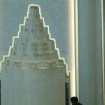 Niche Influencer - A man stands in front of a large mosque