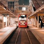 Ad Platforms - A train is traveling through a train station at night