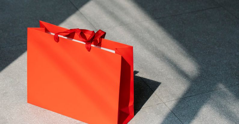 Ad Fraud - Red paper shopping bag on gray ground