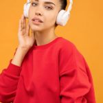 Ppc Trends - Woman in Red Sweatshirt and Blue Jeans Wearing White Headphones