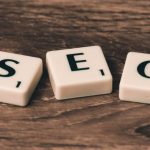 On-page Seo - Three White-and-black Scrabble Tiles on Brown Wooden Surface