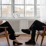 Analytics Social - Person in Black Pants and Black Shoes Sitting on Brown Wooden Chair