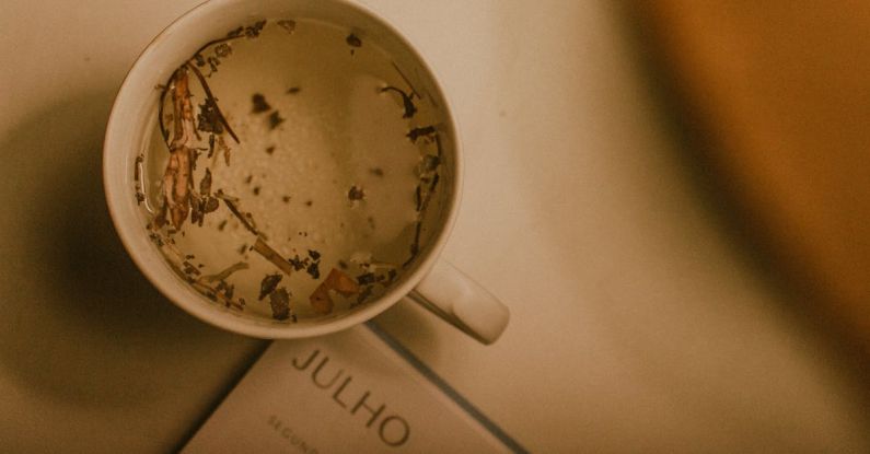 Email Calendar - A cup of tea on a table with a book