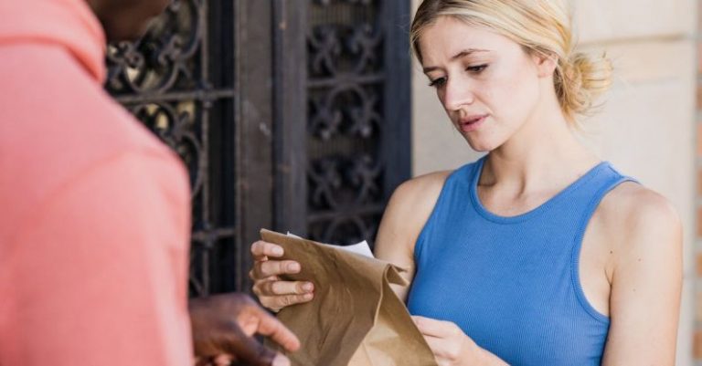 Email List Building - Blonde Woman Checking Ordering List on Paper Bag