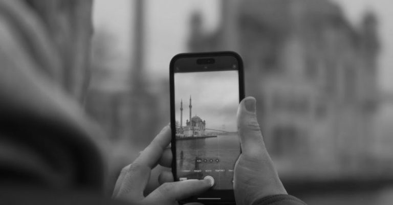 Mobile Optimization - A man taking a photo of a mosque