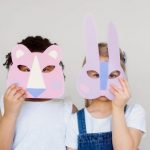 Emotion Design - Two Kids Covering Their Faces With a Cutout Animal Mask