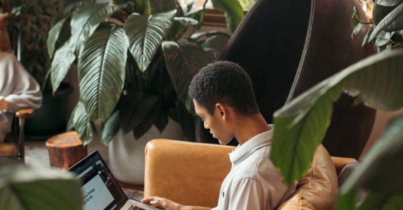 Analytics Strategy - Man in White Dress Shirt Sitting on Brown Chair