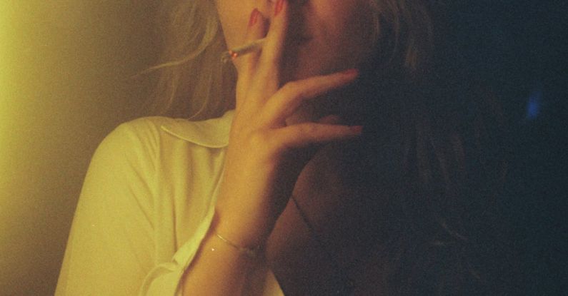 Attribution Model - A woman smoking a cigarette in a dark room