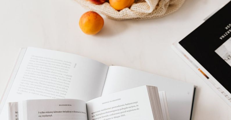 Product Page - Jute sack with appetizing ripe apricots placed on table with different books